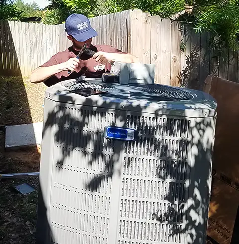 Hard working Air Right technician getting ready to install an American Standard air conditioner